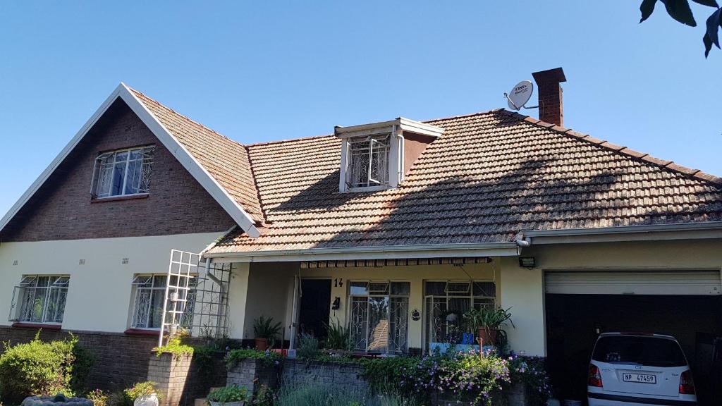 a brown and white house with a roof at Crafty Coal Stove in Pietermaritzburg