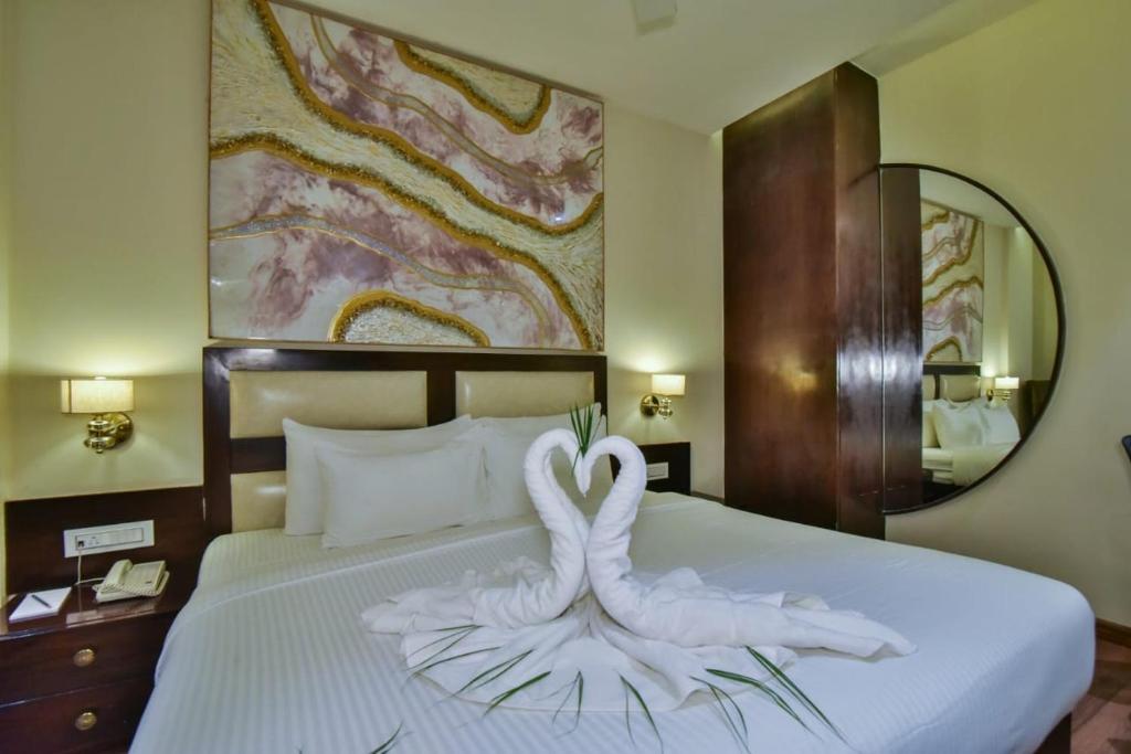 a bedroom with a bed with a swan decoration on it at HOTEL BR INTERNATIONAL in Amritsar