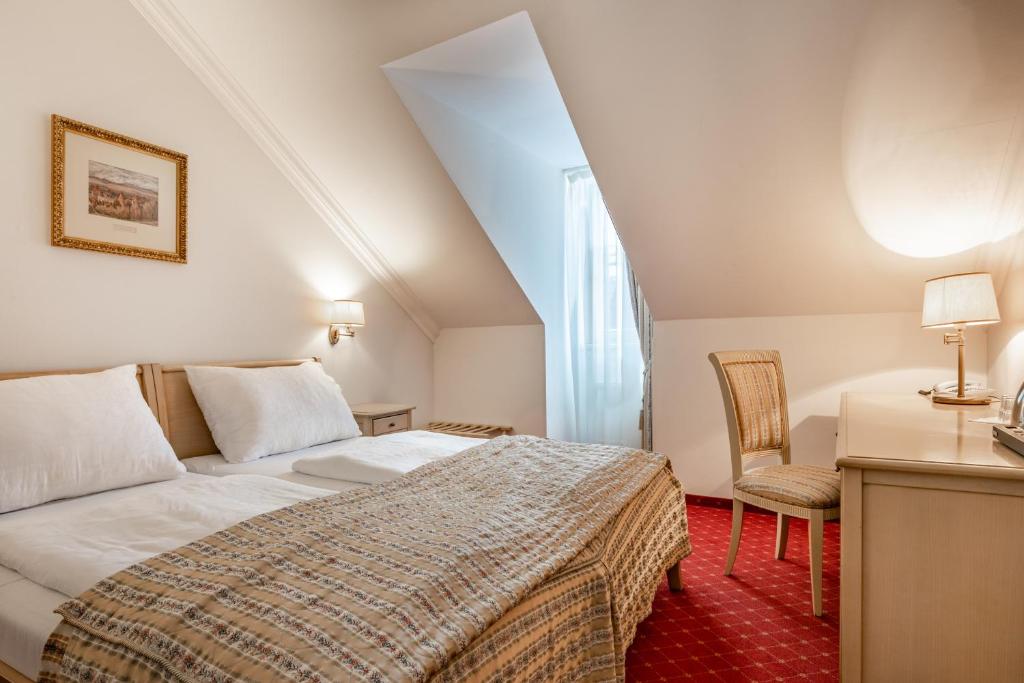 Postel nebo postele na pokoji v ubytování Spa Hotel Schlosspark