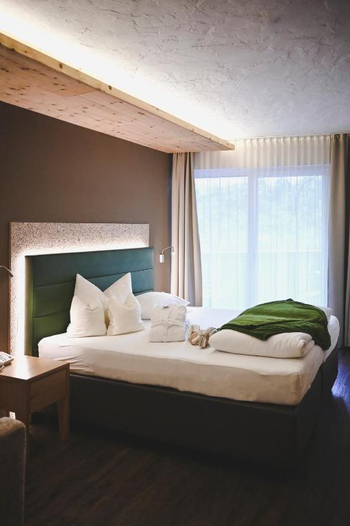 Postel nebo postele na pokoji v ubytování Wiesenhof Gardenresort