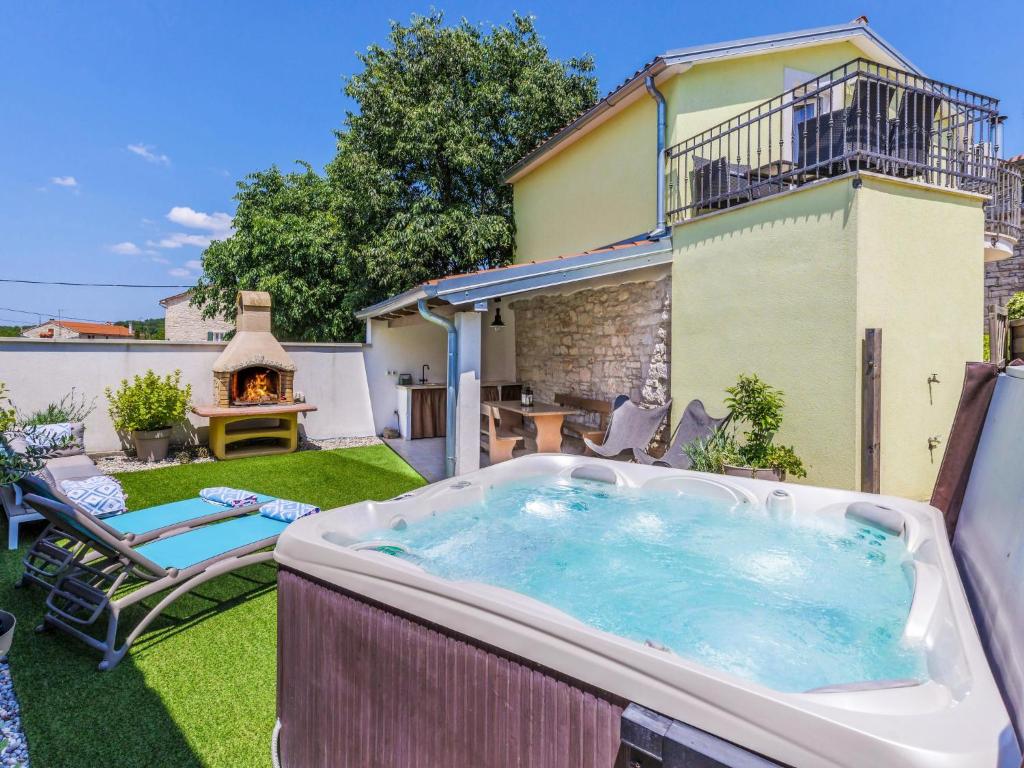 a hot tub in the backyard of a house at Holiday Home Ana by Interhome in Bubani