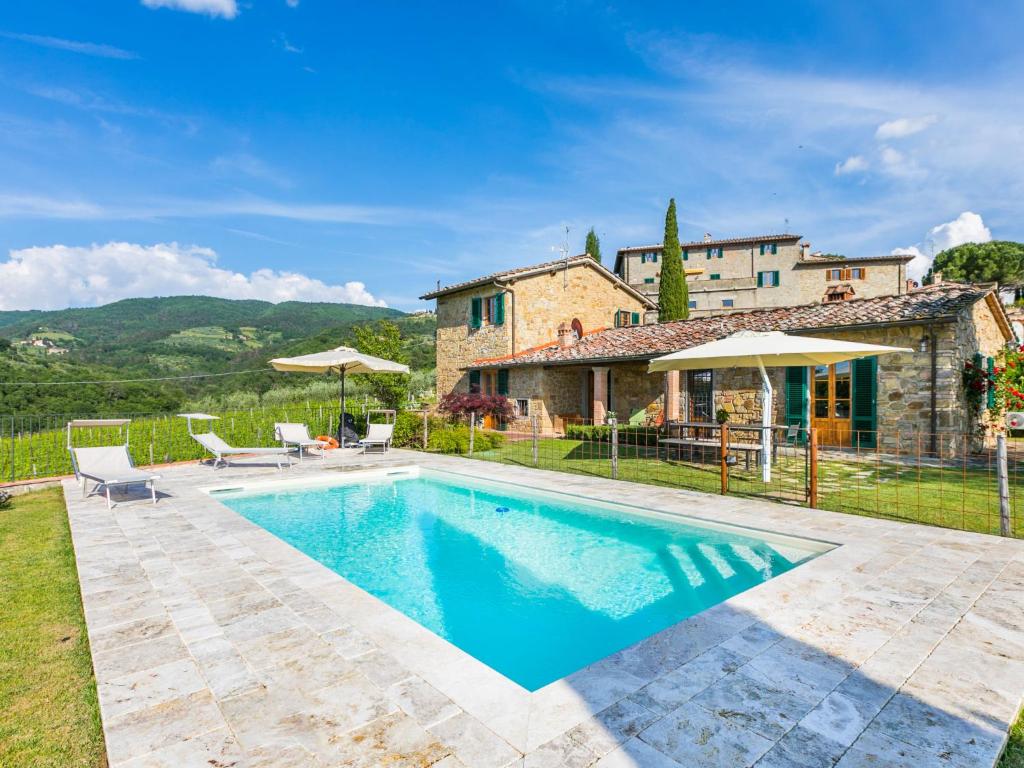 a villa with a swimming pool in front of a house at Holiday Home Casa 360 by Interhome in Greve in Chianti