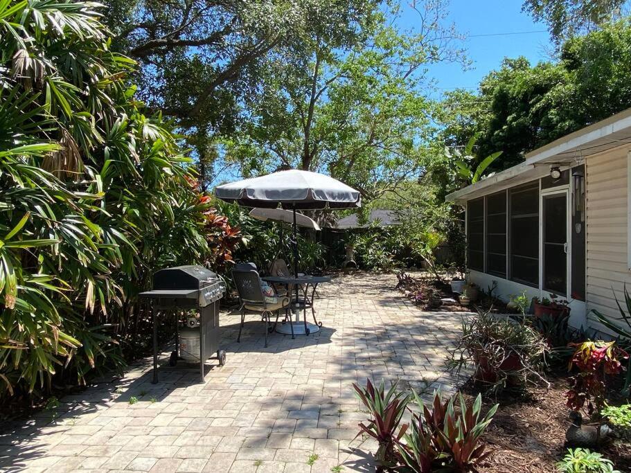 a patio with an umbrella and a table and chairs at One Bed Suite near Beaches and Downtown Sarasota in Sarasota
