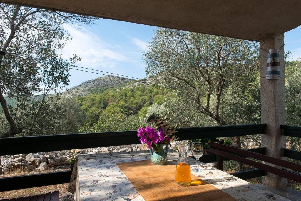 a table on a balcony with a view of a mountain at House Petra in Sali