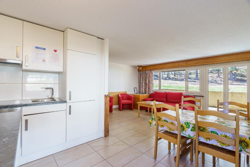 a kitchen and dining room with a table and chairs at Haus Alfa in Saas-Fee