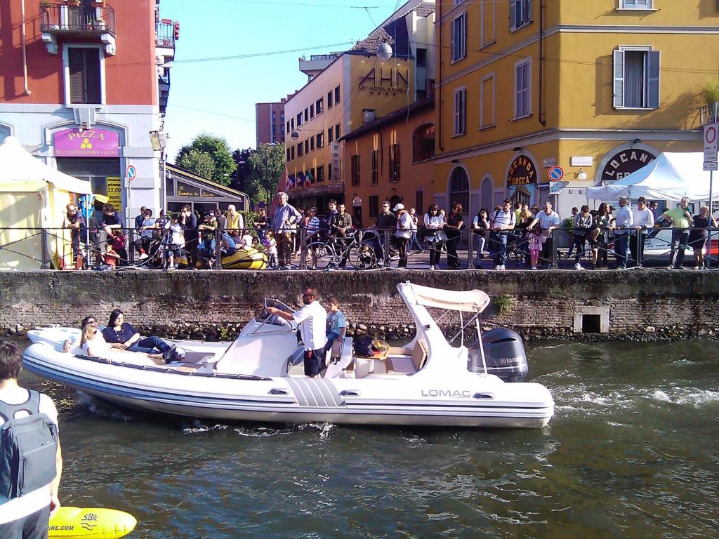 a group of people on a boat in the water at Art Hotel Navigli in Milan