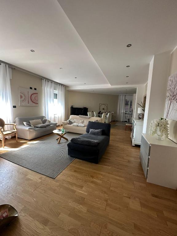 a living room with two couches and a table at Luxury center appartment in Novi Ligure