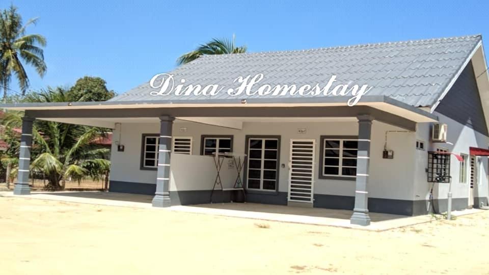 un bâtiment avec un panneau indiquant junima homesteadery dans l'établissement Dina Homestay B, à Pasir Puteh