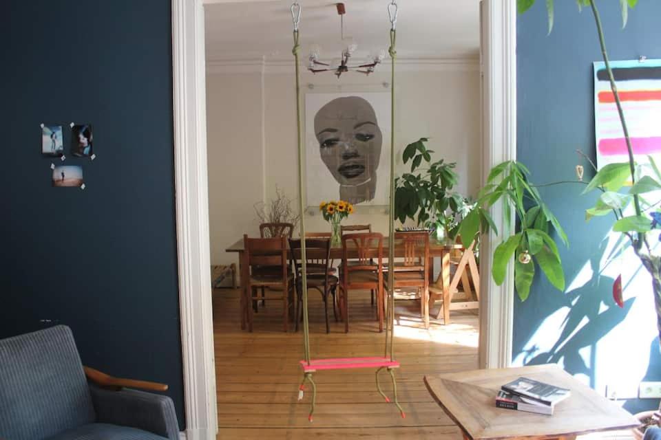 a dining room with a table with a head on the wall at Family Friendly Funhouse Centrally Located in Ottensen in Hamburg