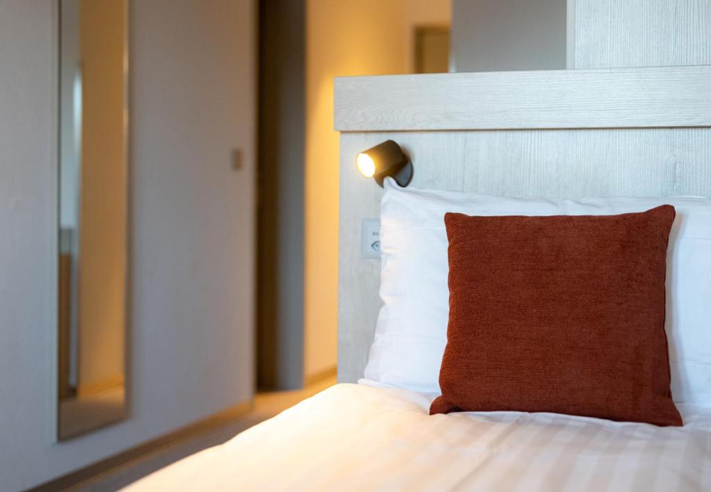 Postel nebo postele na pokoji v ubytování Victoria Hotel & Residence