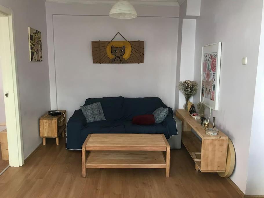 a living room with a blue couch and a table at Bright apartment in Beşiktaş / Abbasağa in Istanbul