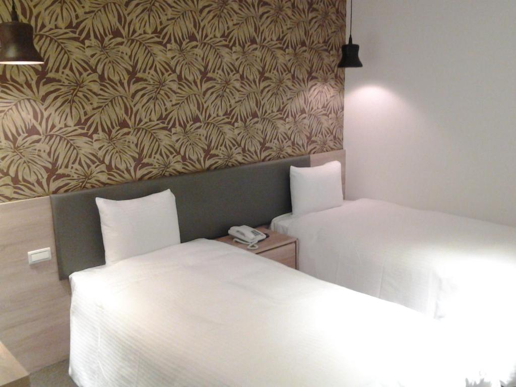 Postel nebo postele na pokoji v ubytování Queens Hotel II