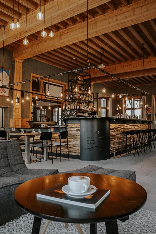 a room with a table and chairs and a bar at Villars Lodge in Villars-sur-Ollon