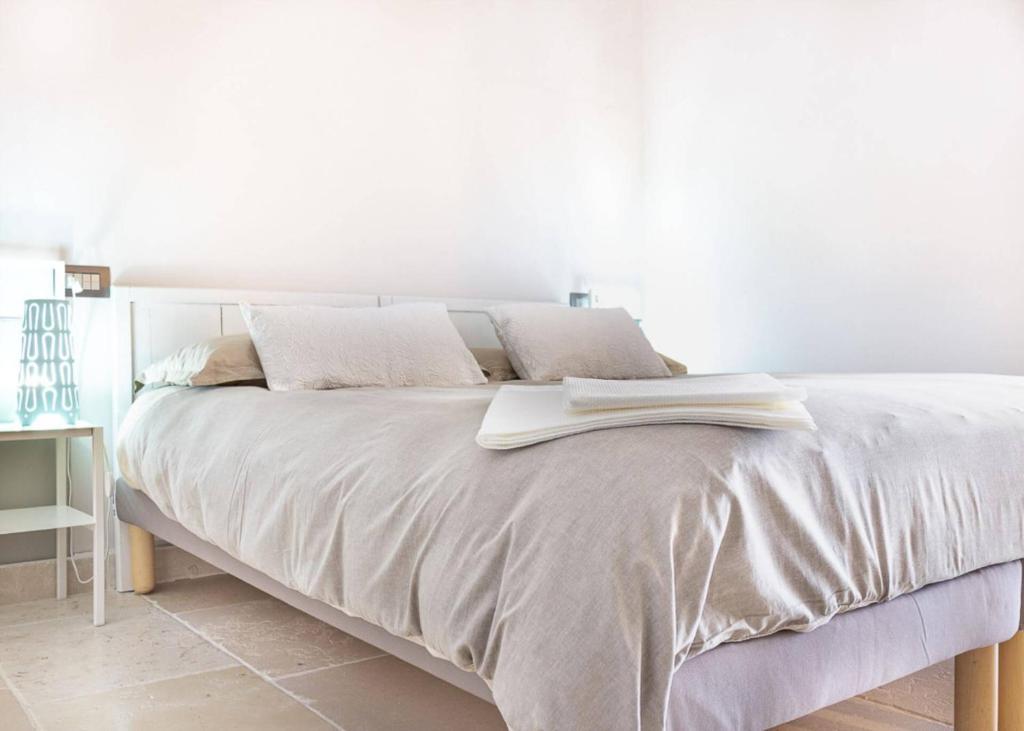 a white bed with an open book on it at Camera Astrid in Casale Alxi