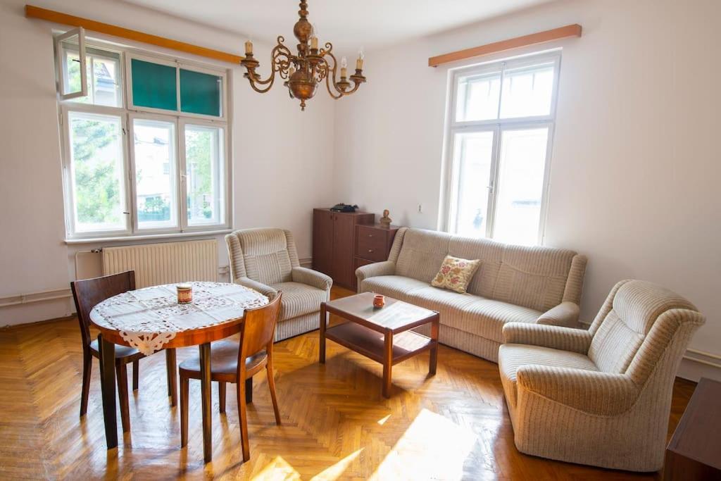 a living room with a table and chairs at Socialist Experience in the City Center in Ljubljana
