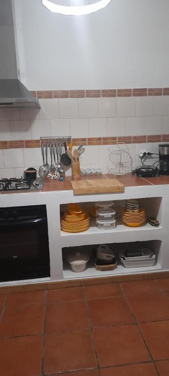 a kitchen with a counter with plates and a stove at Quinta Meneses in Santa Cruz