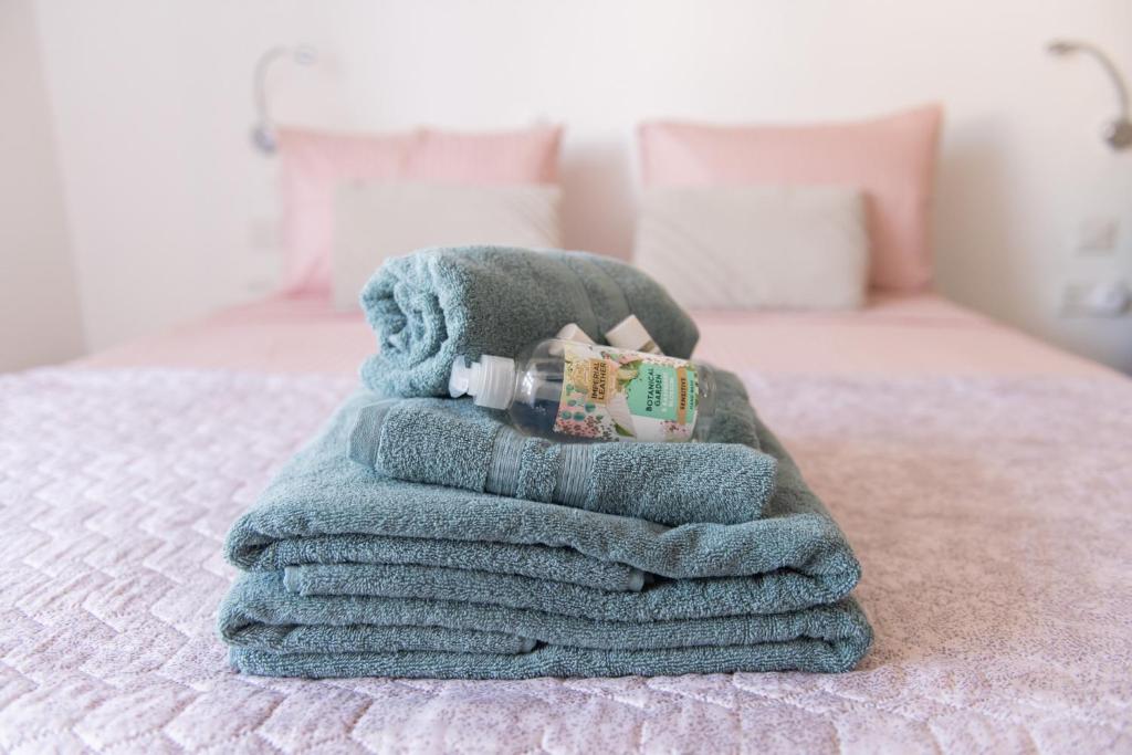 a pile of towels sitting on top of a bed at Privilege suits Swatar in Birkirkara