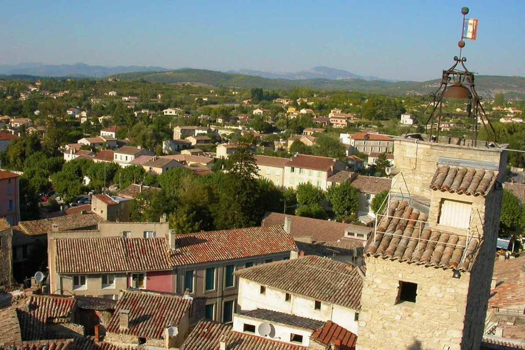 a view of a town with houses and roofs at Studio Meuble Pied Du Ventoux in Malaucène