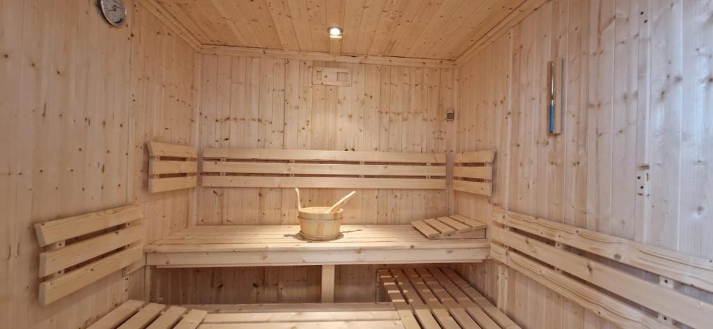 an empty wooden sauna with a bucket in it at YASI Hostel in Lyon