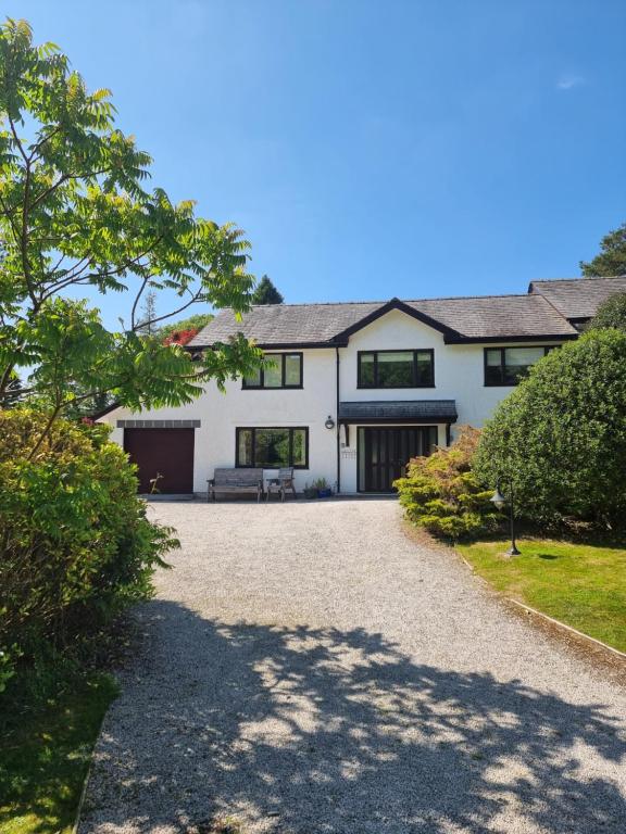 a large white house with a driveway at Wansfell in Ambleside