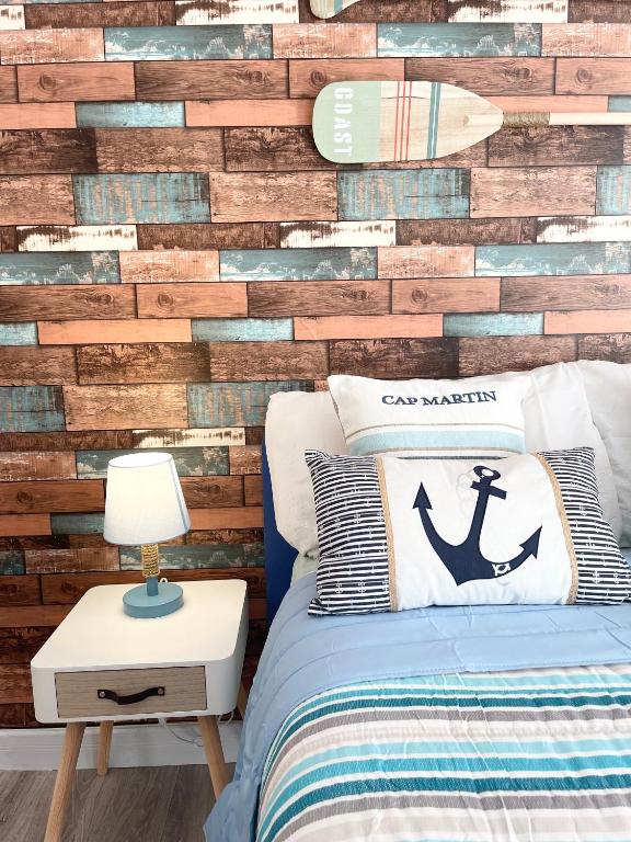 a bedroom with a wall made out of reclaimed wood at Home and Relax ROOMS in Furnari