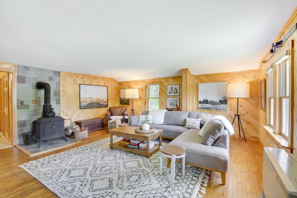 a living room with a couch and a fireplace at Gorgeous Sunday River Cabin with Saltwater Hot Tub! in Newry