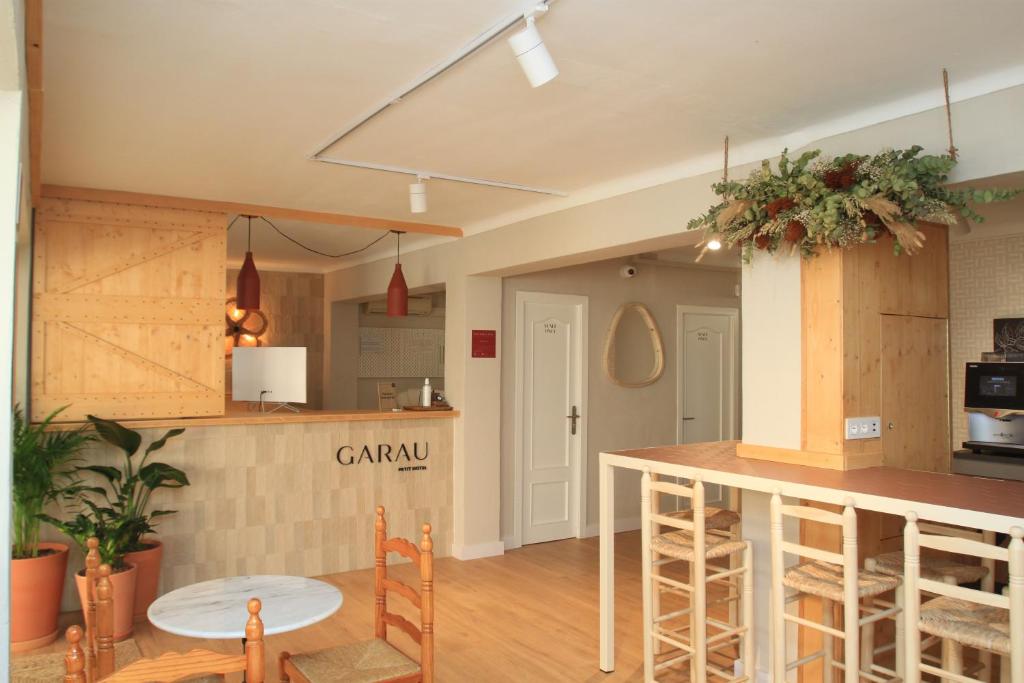 a kitchen with a counter and a table in a room at Garau Petit Hotel in El Arenal