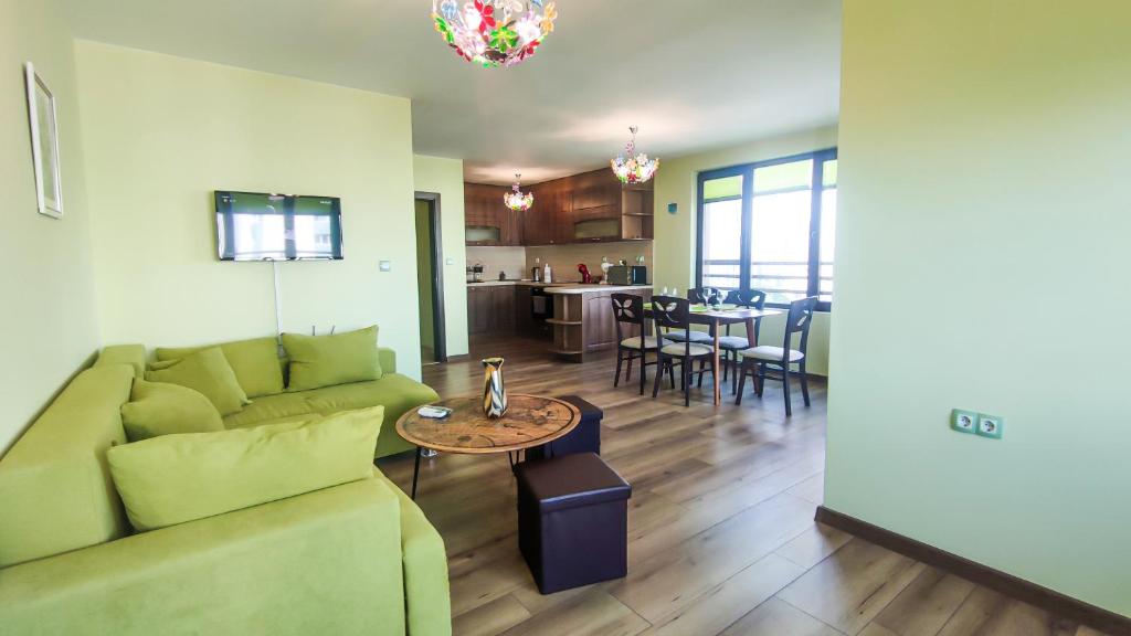 a living room with a couch and a table at Апартаменти за гости Делукс in Burgas City