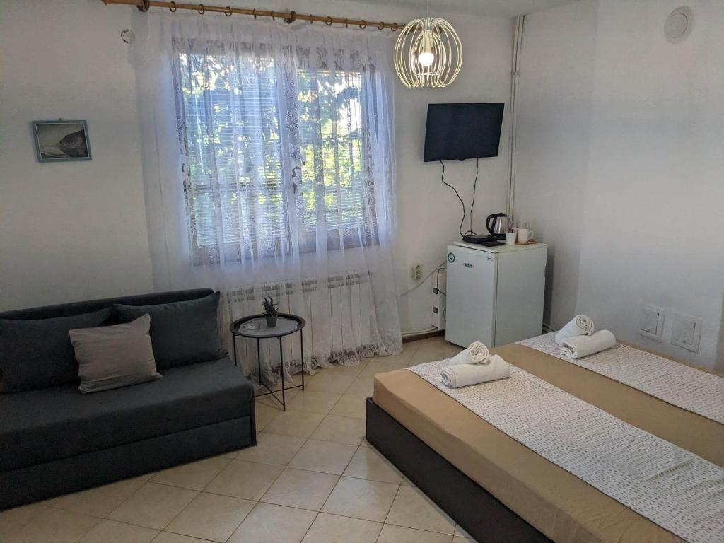 uma sala de estar com duas camas e um sofá em Цвета em Sinemorets