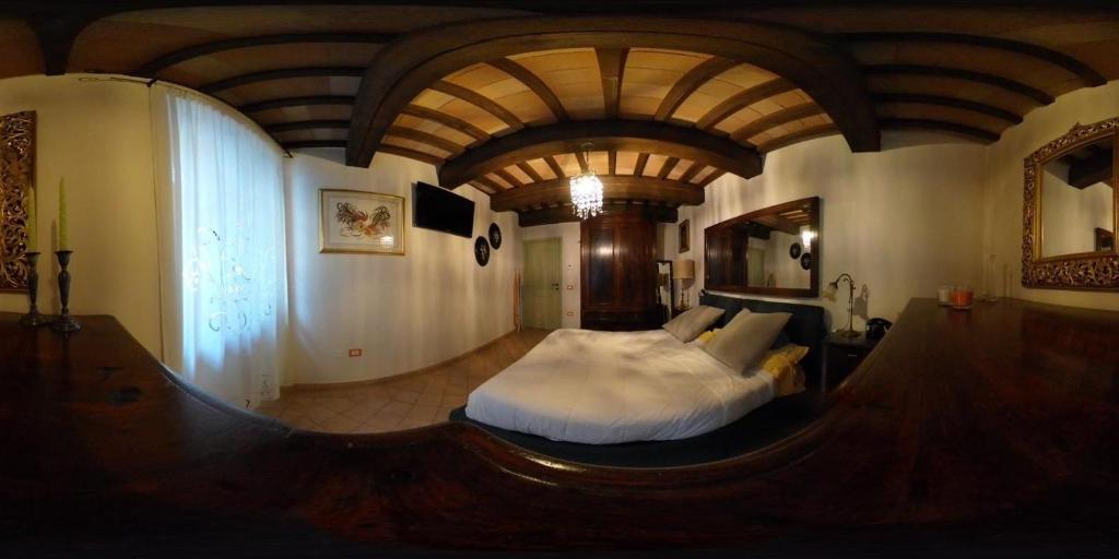a bedroom with a large bed in the middle of a room at Casa Banino in Cagli