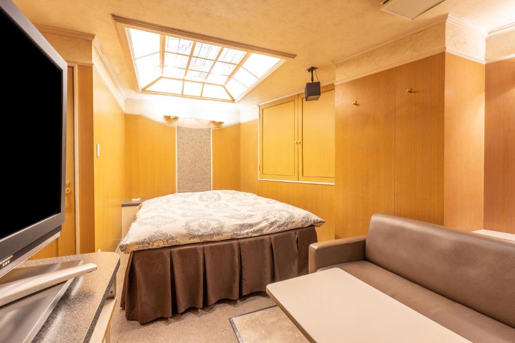 Postel nebo postele na pokoji v ubytování リトルドルフィン岐阜 -大人専用-
