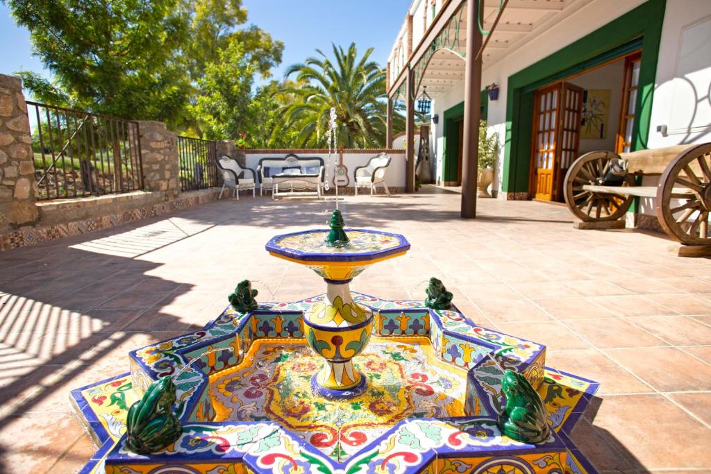 a fountain on the patio of a house at Villa Cultural MONTELUCÍA in Montecorto