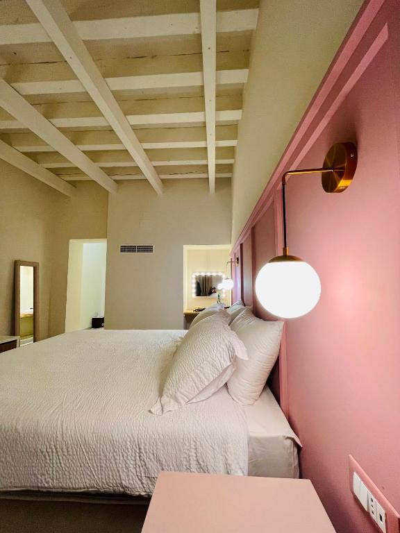 Postel nebo postele na pokoji v ubytování Palazzo Matà Boutique Hotel