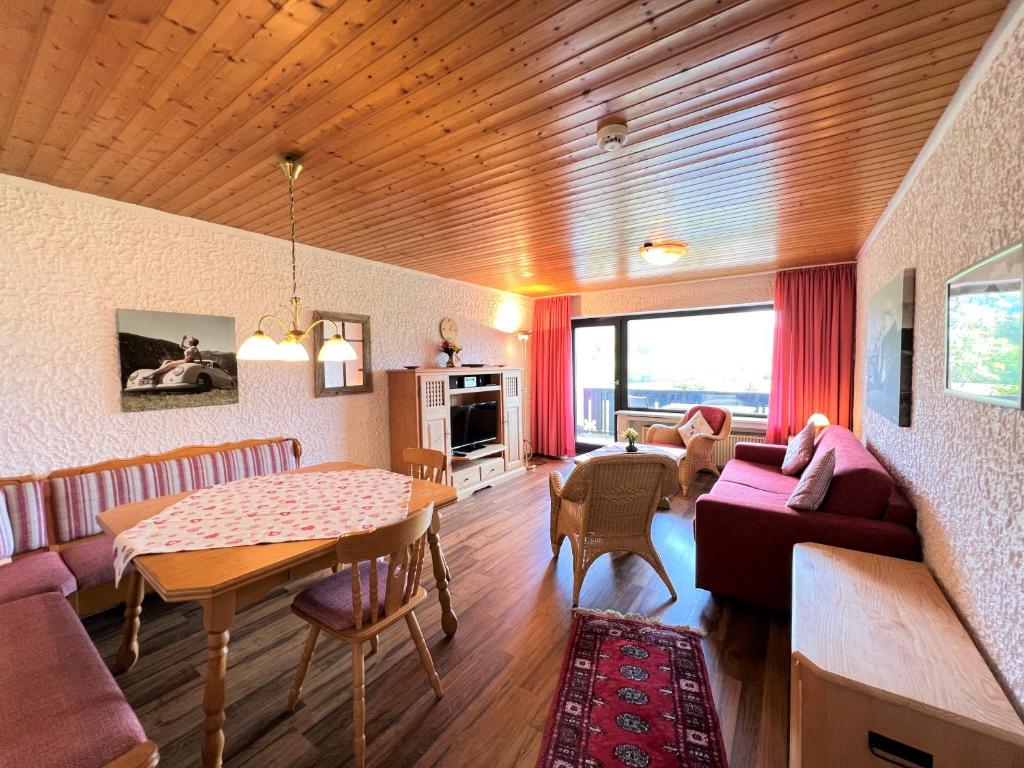 a living room with a couch and a table at Allgäu Appartementhaus Appartement ALLGÄU 09 in Pfronten