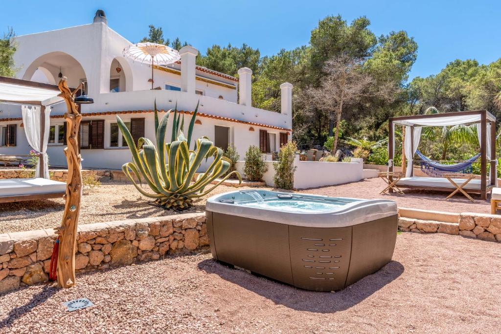 a house with a hot tub in the yard at Sunset Villa Cala Tarida & Cala Comte & Cala Bassa in Port des Torrent