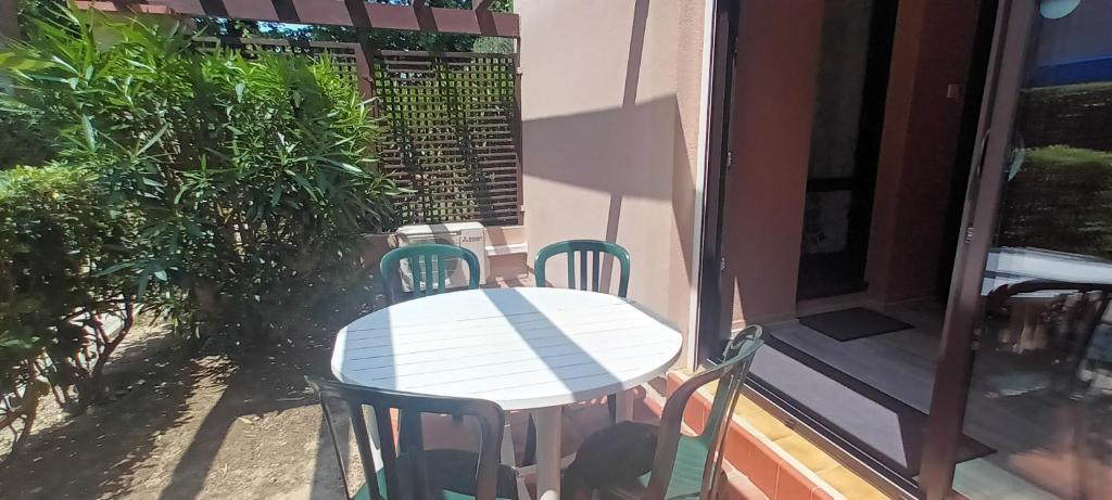 une table et des chaises sur le balcon d'une maison dans l'établissement Les Bastides Au calme joli appartement avec terrasse - Parking - Piscine - Clim, à Saint-Cyprien