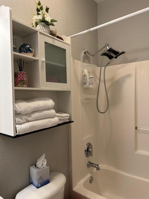 a bathroom with a shower and a toilet and a sink at Quiet room in a family home in Lehigh Acres