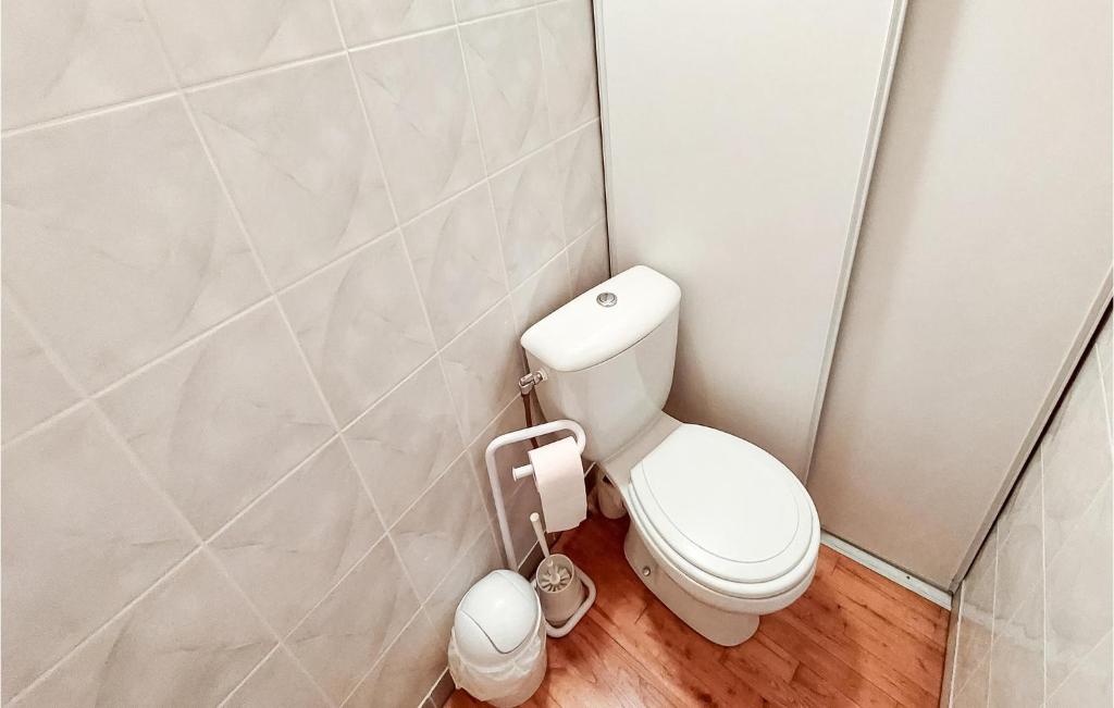 a bathroom with a toilet and a toilet paper dispenser at Amazing Home In Essertines-en-chtelne With 3 Bedrooms in Essertines-en-Châtelneuf