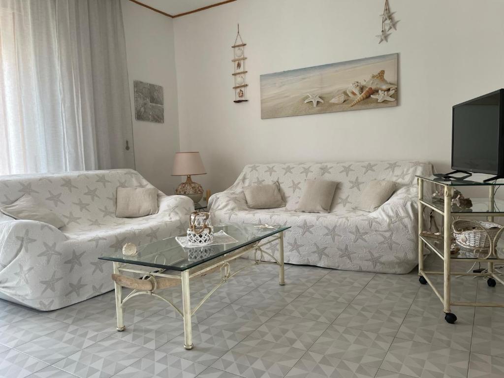 a living room with a couch and a coffee table at CASE DEL MAR nel centro storico in Santa Teresa Gallura