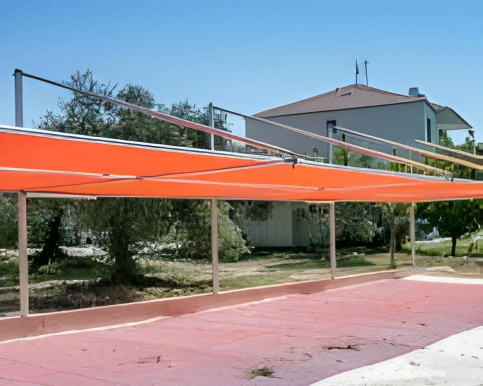 a large orange metal structure on a basketball court at Villa Elista in Astris