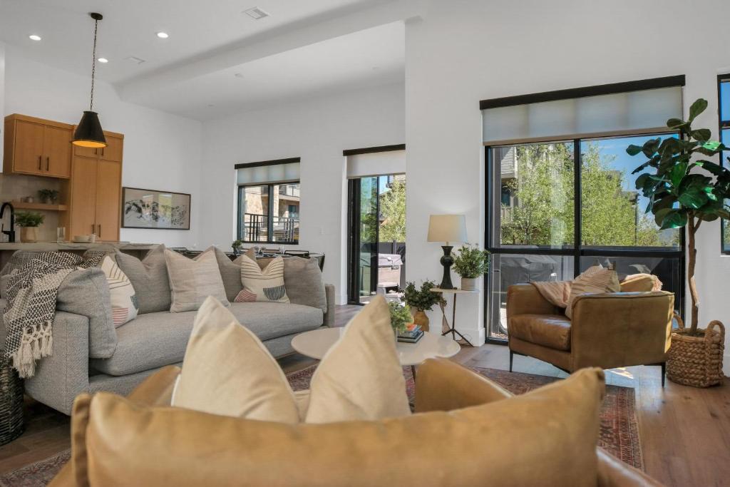 a living room with a couch and a table at Stone Hollow 1884 townhouse in Park City