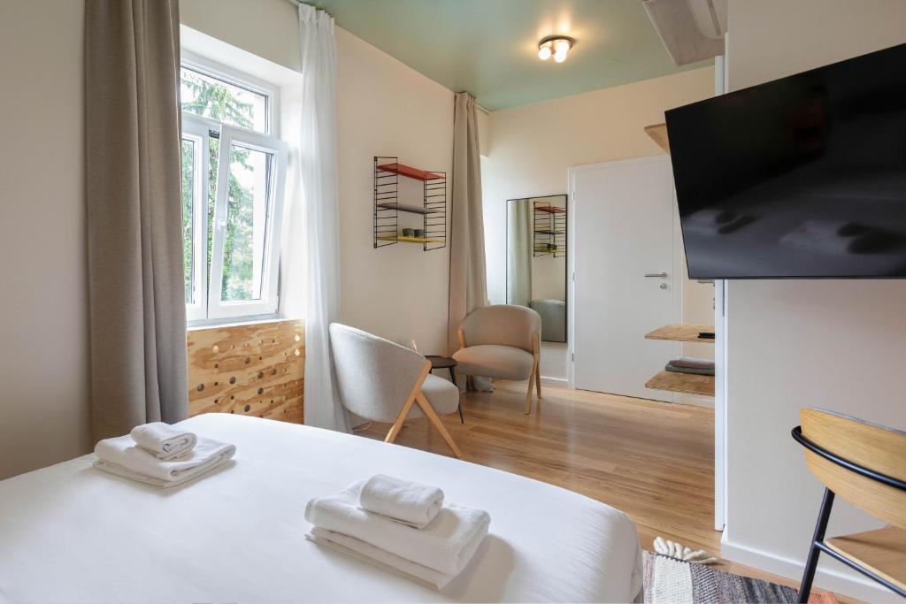 a room with a bed with two towels on it at Flok Tkalciceva - Main Street Rooms & Apartments in Zagreb