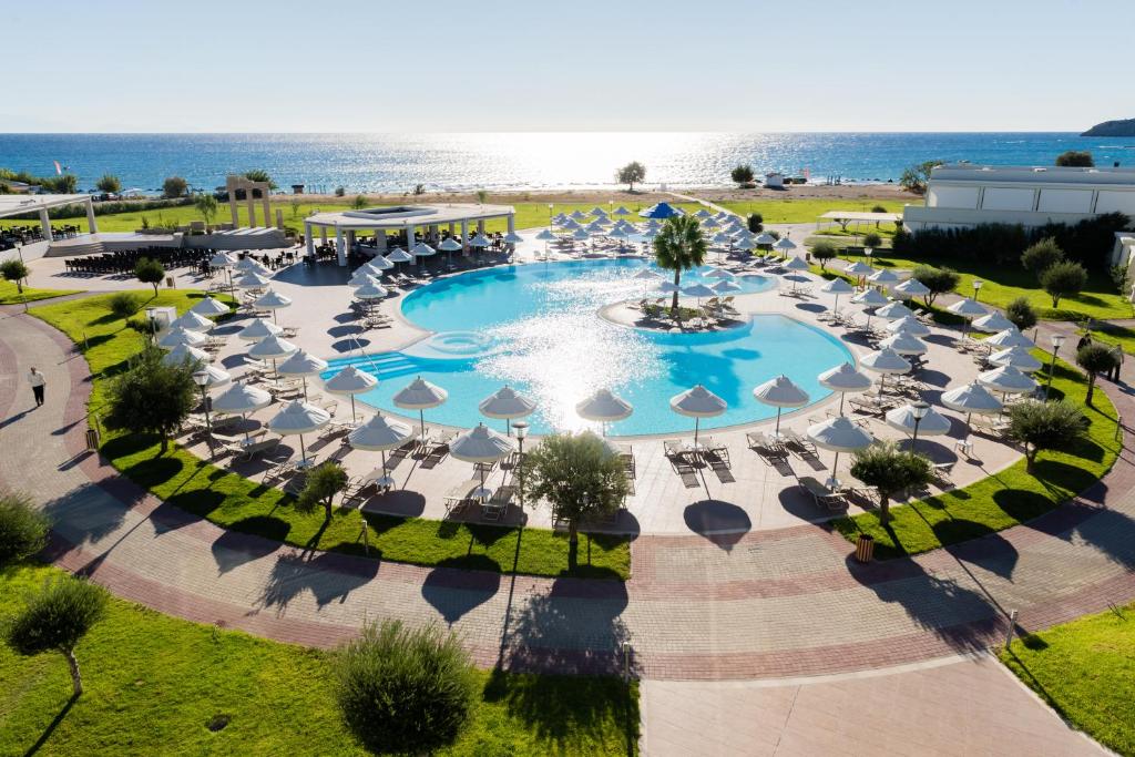 an aerial view of a resort with a pool and chairs at Apollo Blue in Faliraki