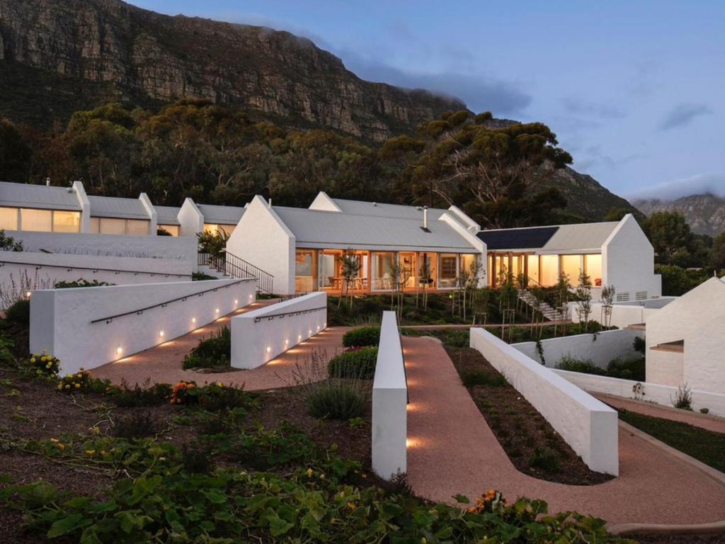 a house with a mountain in the background at Umoya Boutique Hotel & Villas in Cape Town