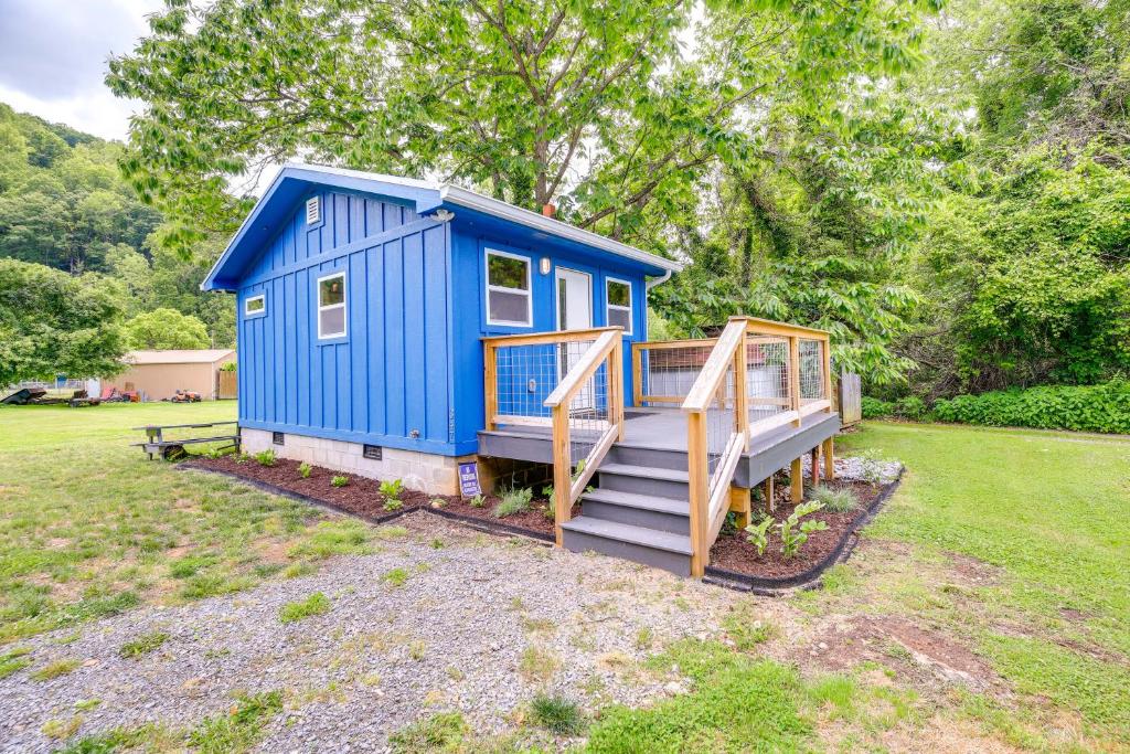 a blue tiny house with a staircase in a yard at Cozy Hikers Hideaway Steps From Creeper Trail! in Damascus