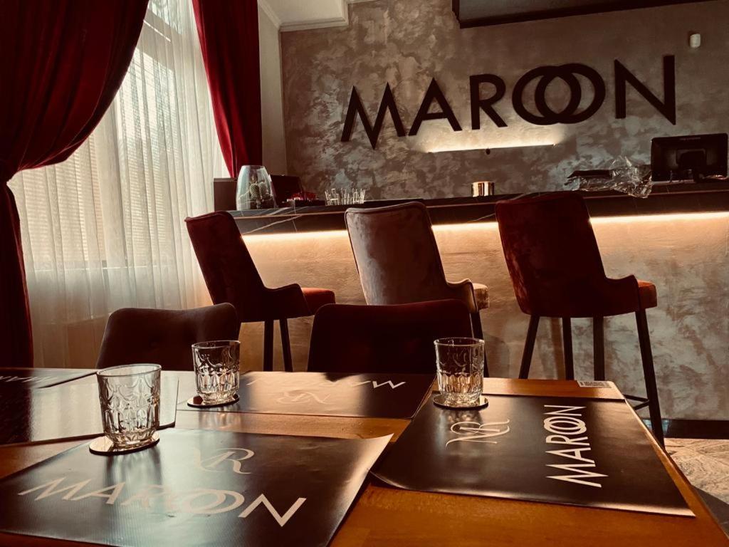 a restaurant with a bar with a maroon sign on a table at Maroon pension in Piešťany