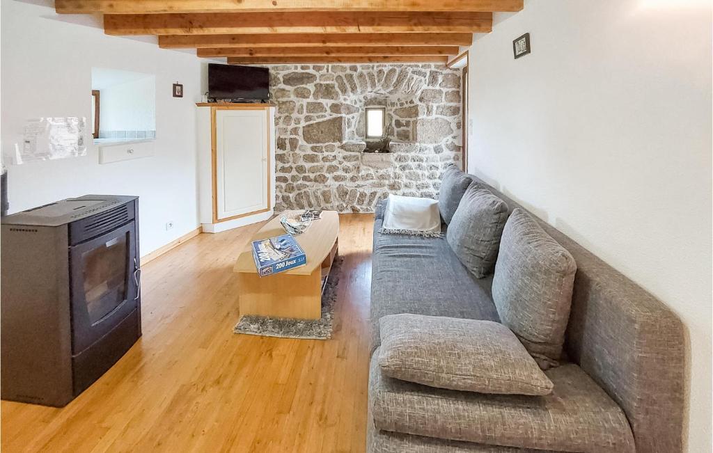 a living room with a couch and a tv at Amazing Home In Essertines-en-chtelne With 3 Bedrooms in Essertines-en-Châtelneuf