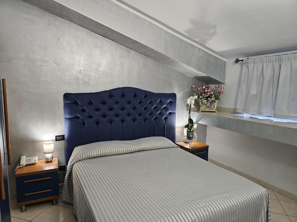 Postel nebo postele na pokoji v ubytování Hotel Il Gioiello