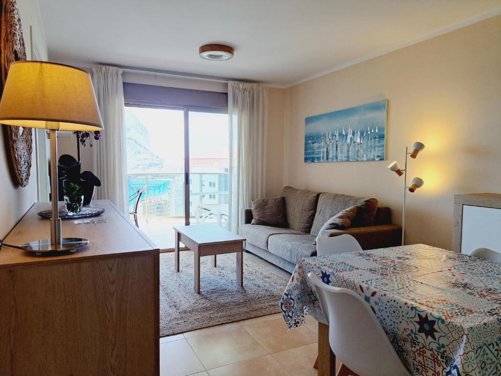 a living room with a couch and a table at Esmeralda seaview in Calpe