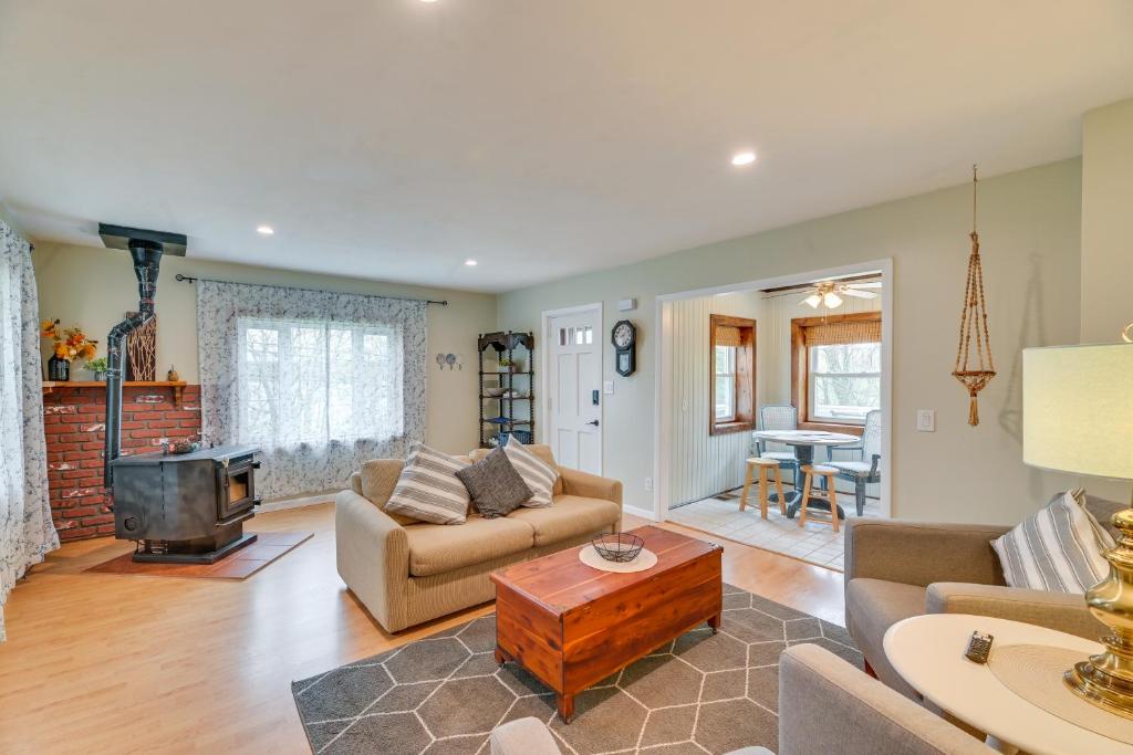 a living room with a couch and a tv at Charming Canandaigua Lake House w/ Deck & Views! in Rushville